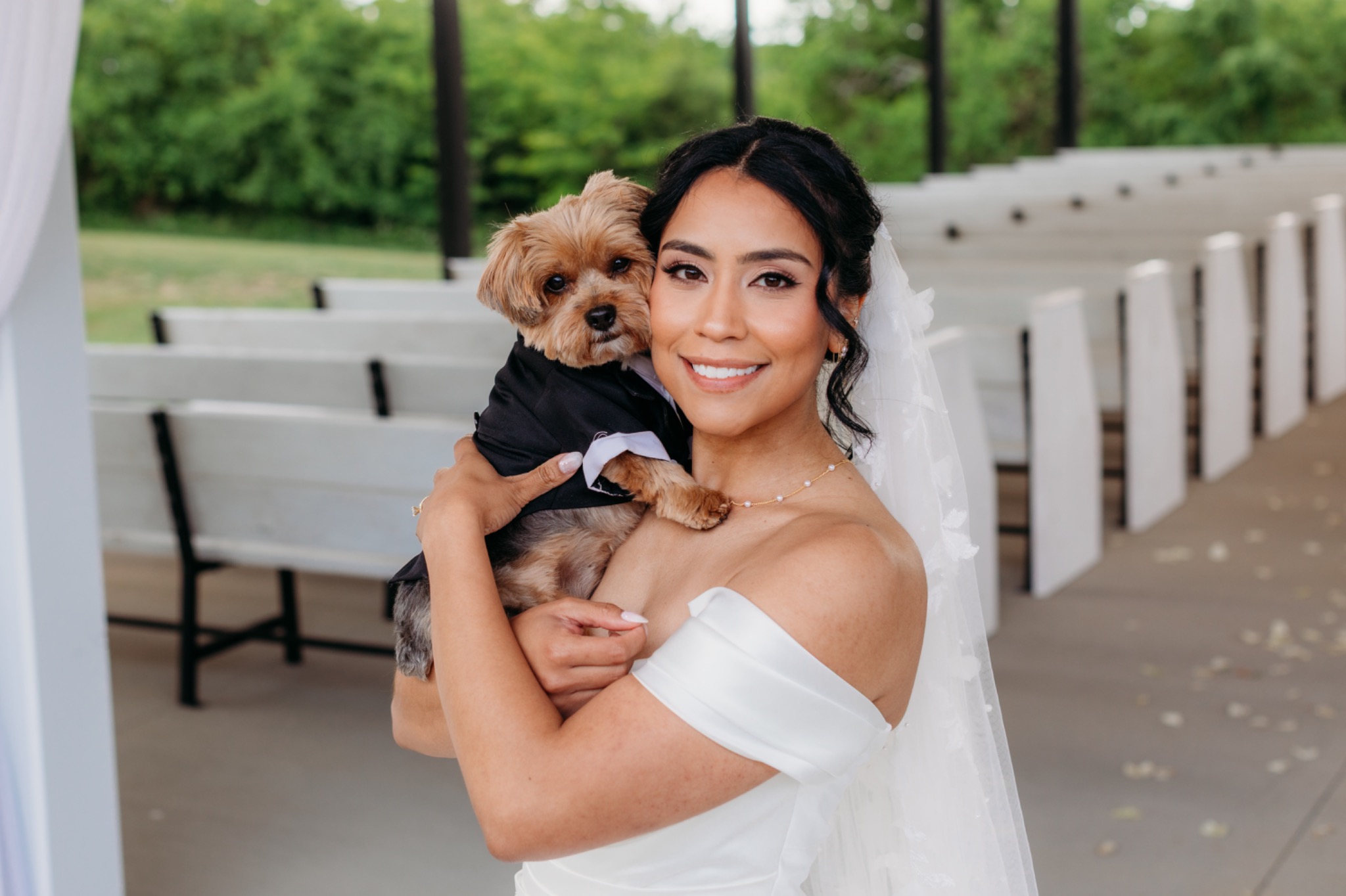 Bride holding her dog before the ceremony