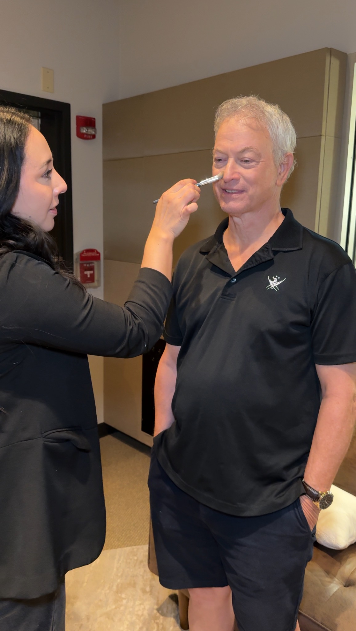 Belem Trevino preparing actor Gary Sinise for camera
